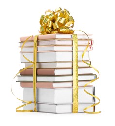 Photo of Stack of books with golden bow as gift isolated on white