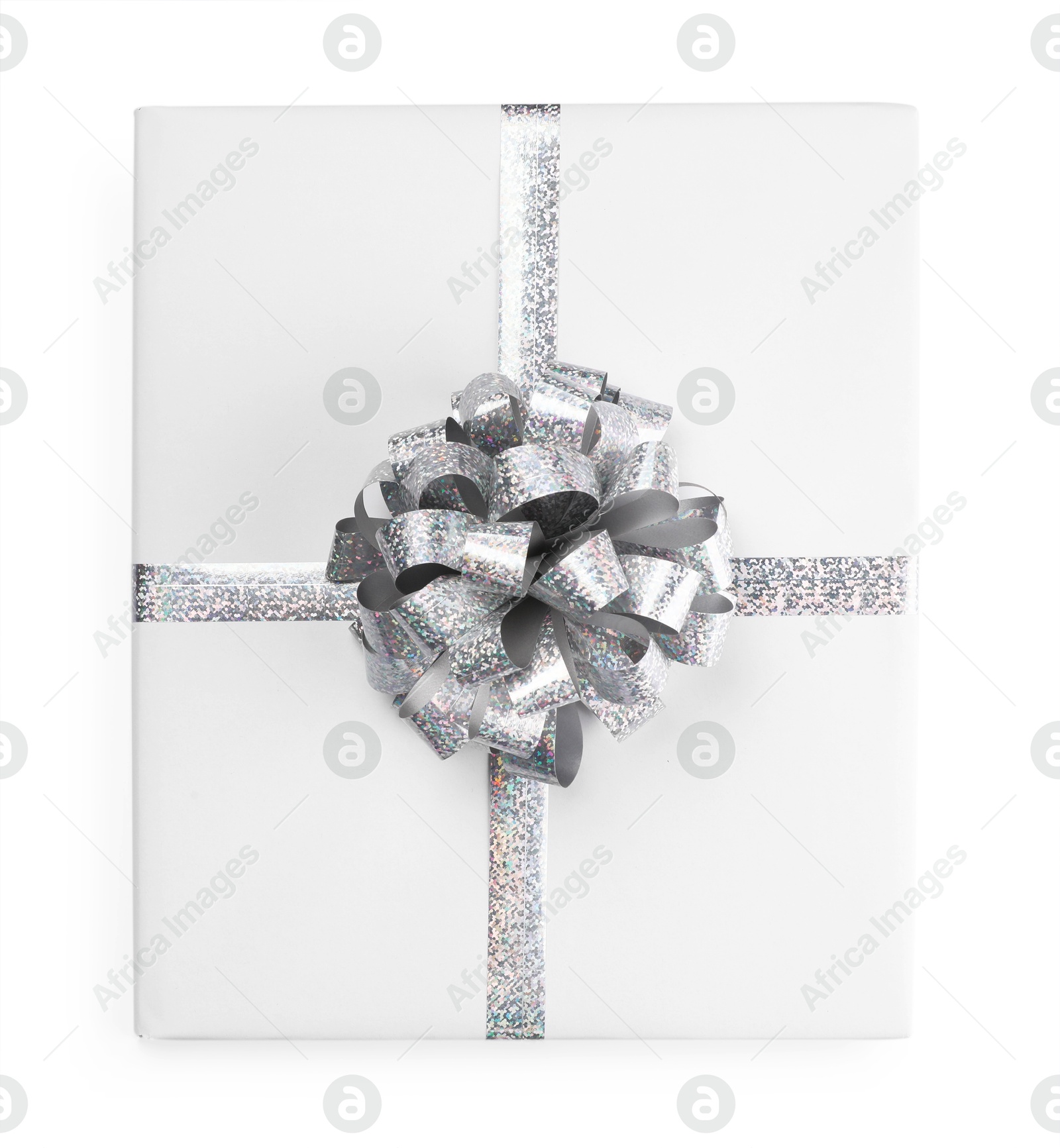 Photo of One book with silver bow as gift isolated on white, top view