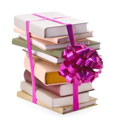 Photo of Stack of books with purple bow as gift isolated on white