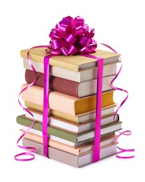 Photo of Stack of books with purple bow as gift isolated on white