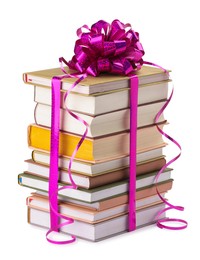 Photo of Stack of books with purple bow as gift isolated on white