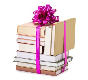 Photo of Stack of books with purple bow as gift isolated on white