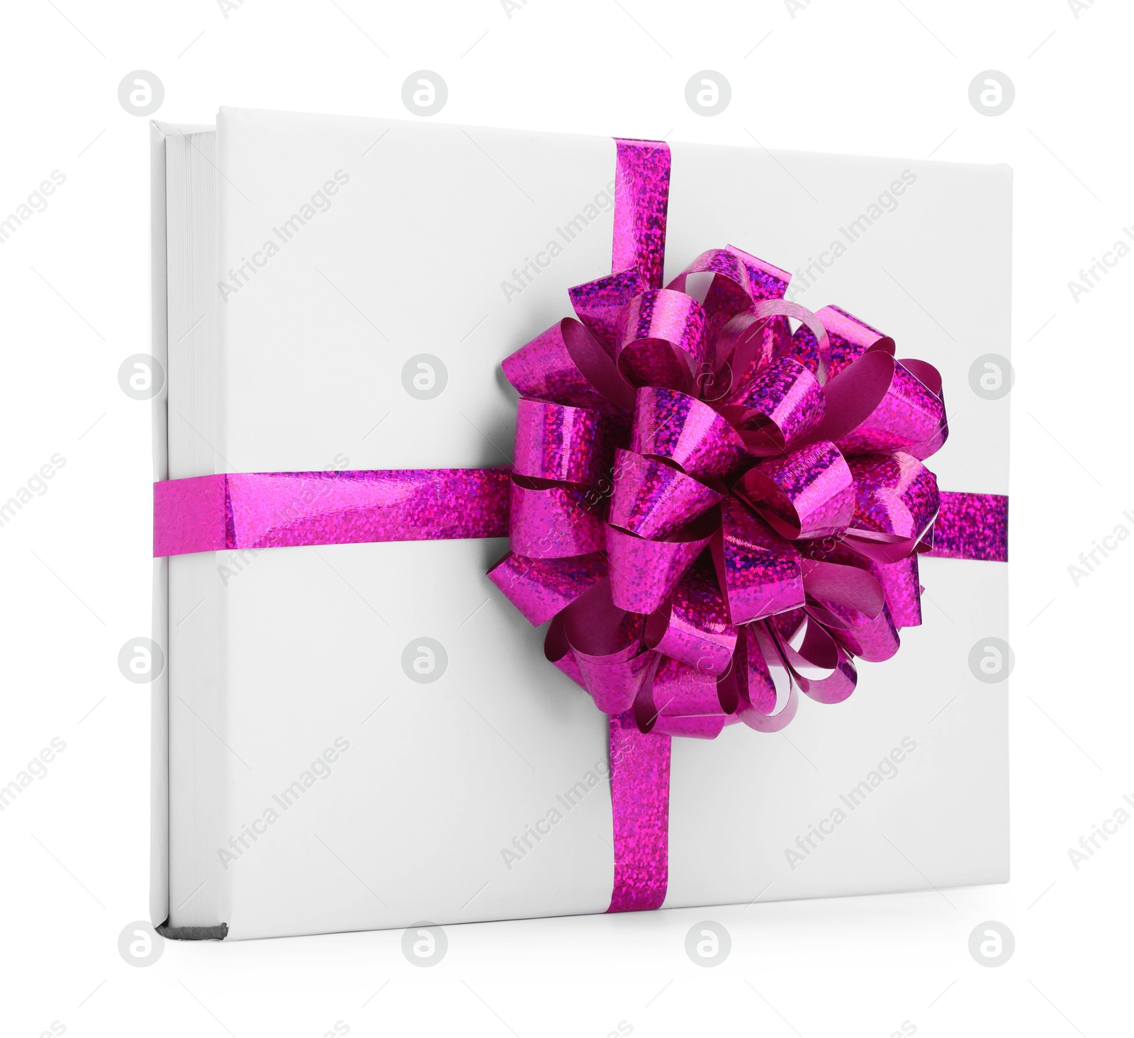 Photo of One book with purple bow as gift isolated on white