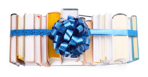 Photo of Books with blue bow as gift isolated on white, top view