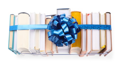 Photo of Books with blue bow as gift isolated on white, top view