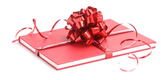 Photo of One book with red bow as gift isolated on white