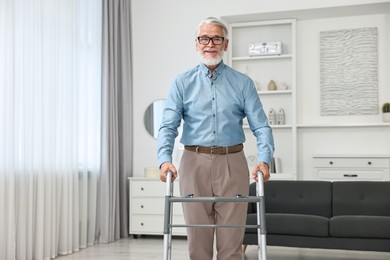 Photo of Senior man using walking frame at home