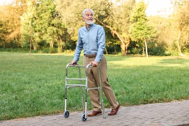 Photo of Senior man with walking frame in park