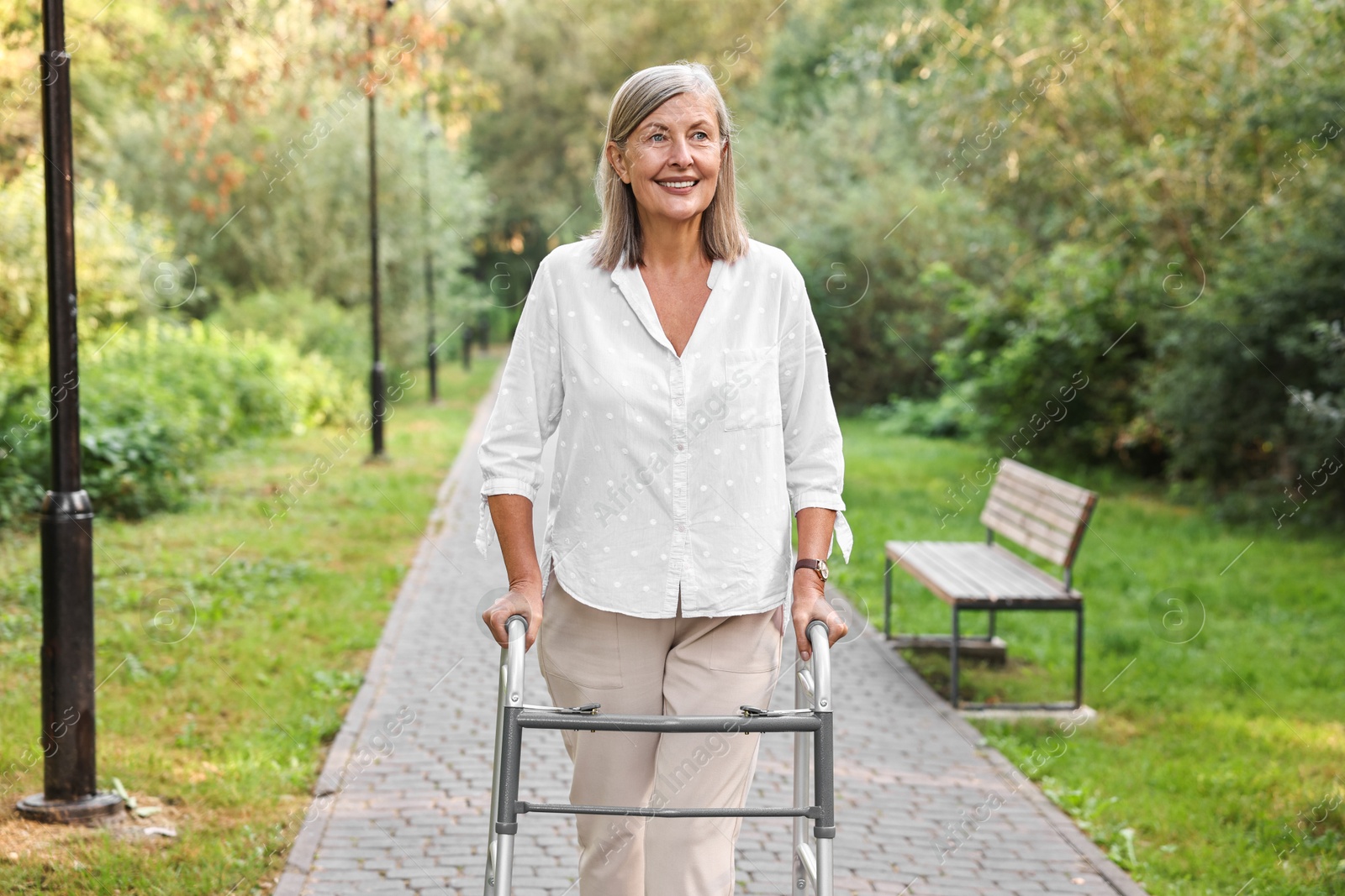 Photo of Senior woman with walking frame in park