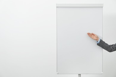 Photo of Woman near flip chart on white background, closeup. Mockup for design