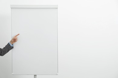 Photo of Woman near flip chart on white background, closeup. Mockup for design