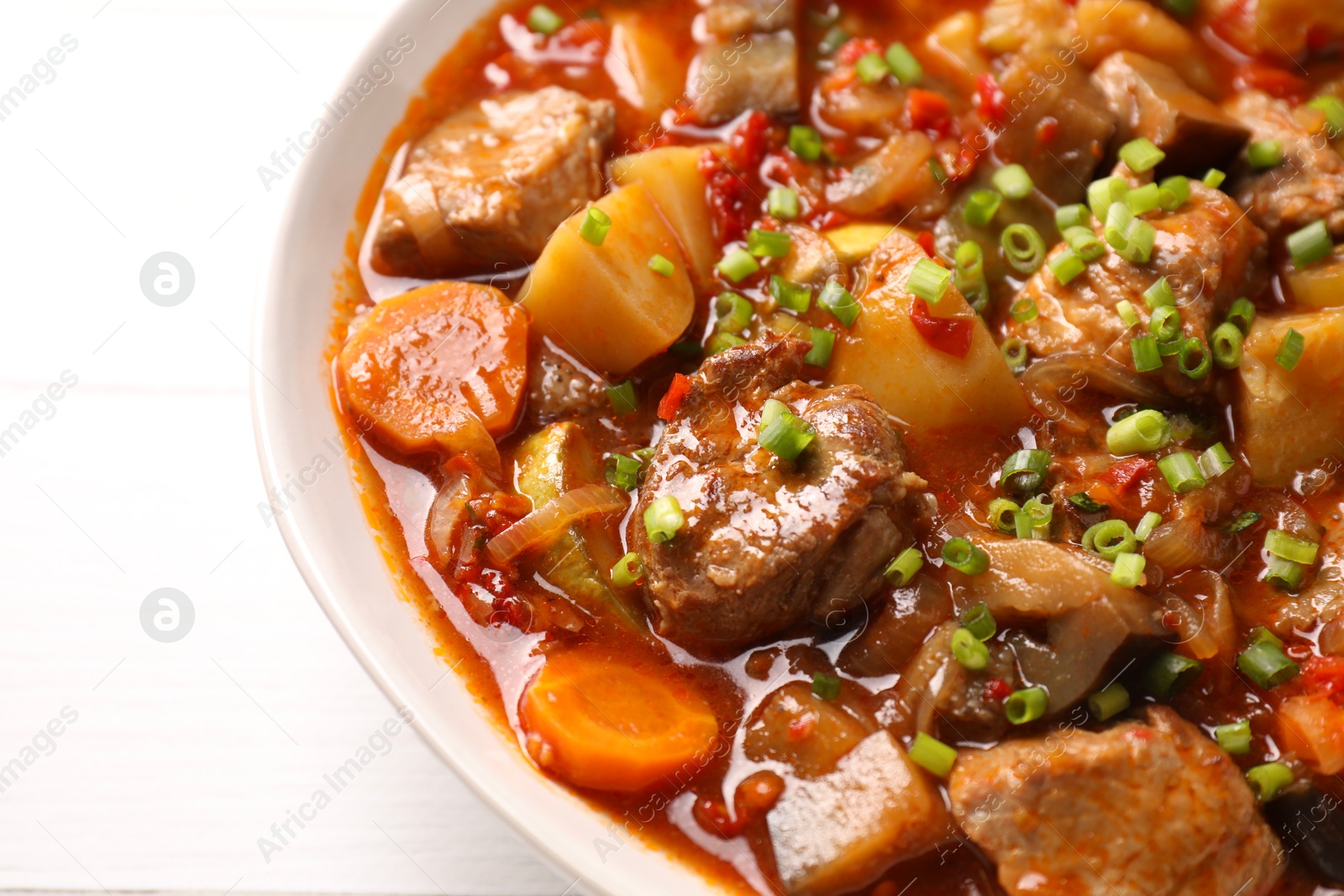 Photo of Delicious stew with vegetables in bowl on table, closeup