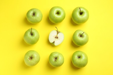 Photo of Flat lay composition with half of apple surrounded by ones on yellow background