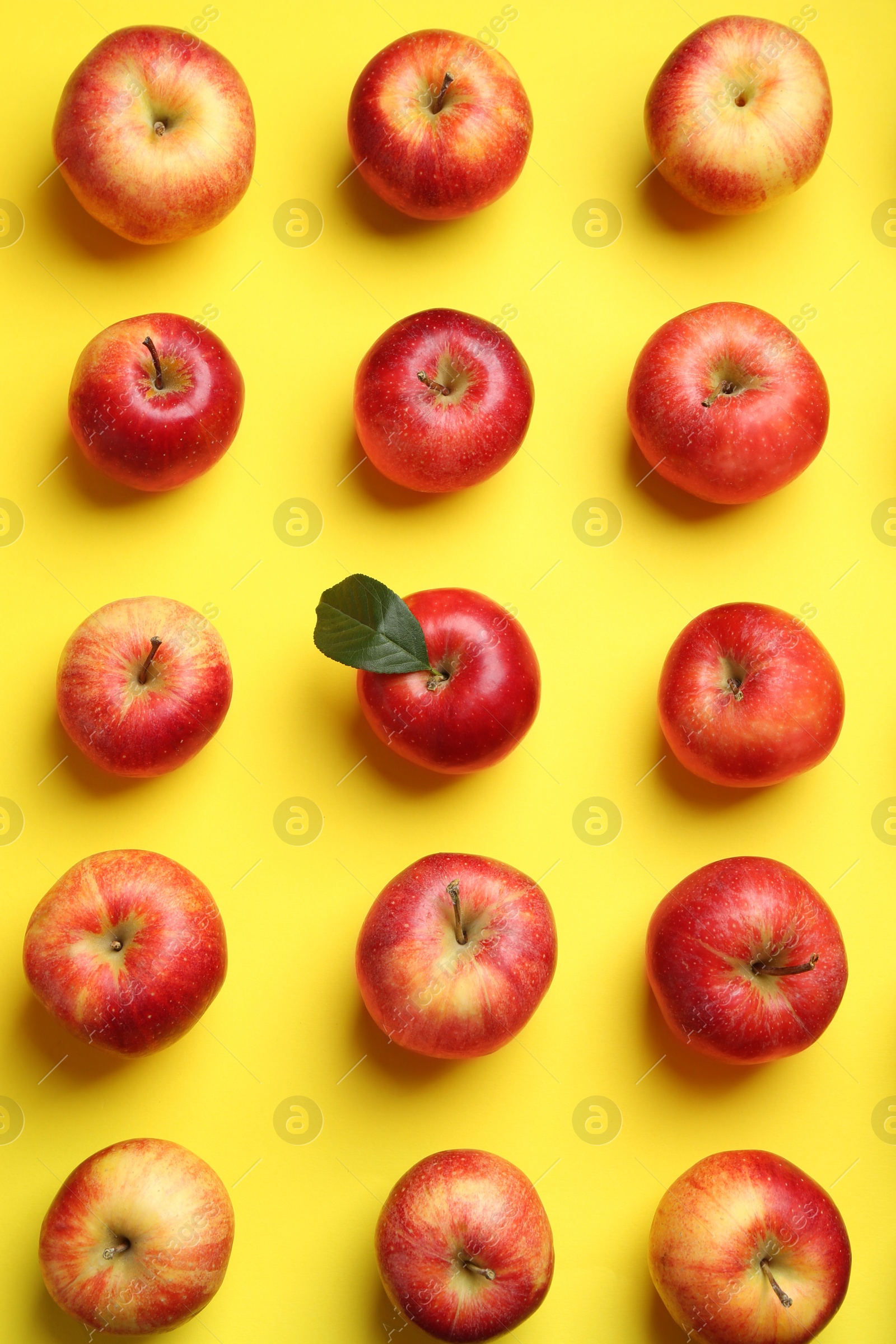 Photo of Flat lay composition with many red apples on yellow background