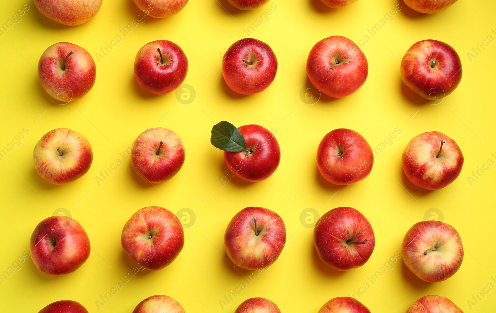 Photo of Flat lay composition with many red apples on yellow background