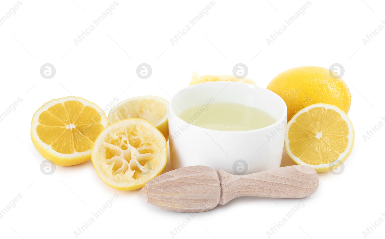 Photo of Fresh lemon juice in bowl, squeezer and fruits isolated on white