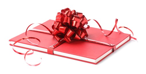 Photo of One book with red bow as gift isolated on white