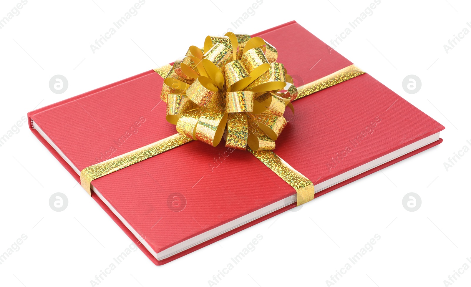 Photo of One book with golden bow as gift isolated on white