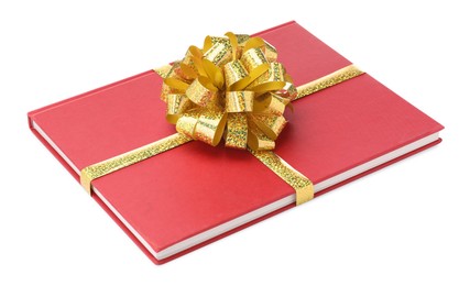 Photo of One book with golden bow as gift isolated on white