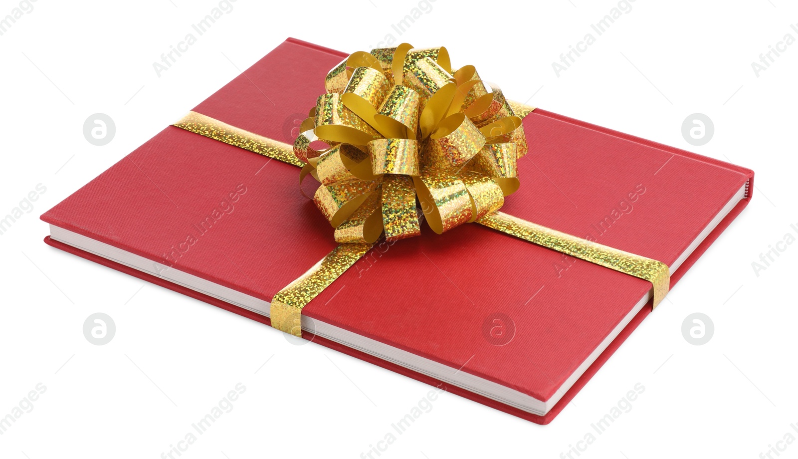 Photo of One book with golden bow as gift isolated on white