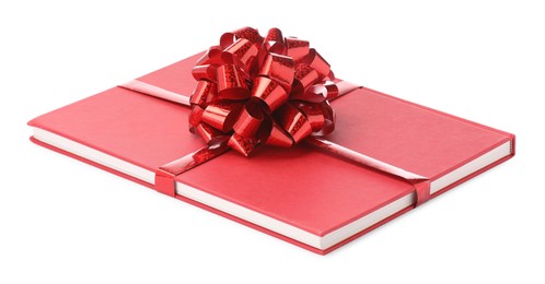 Photo of One book with red bow as gift isolated on white