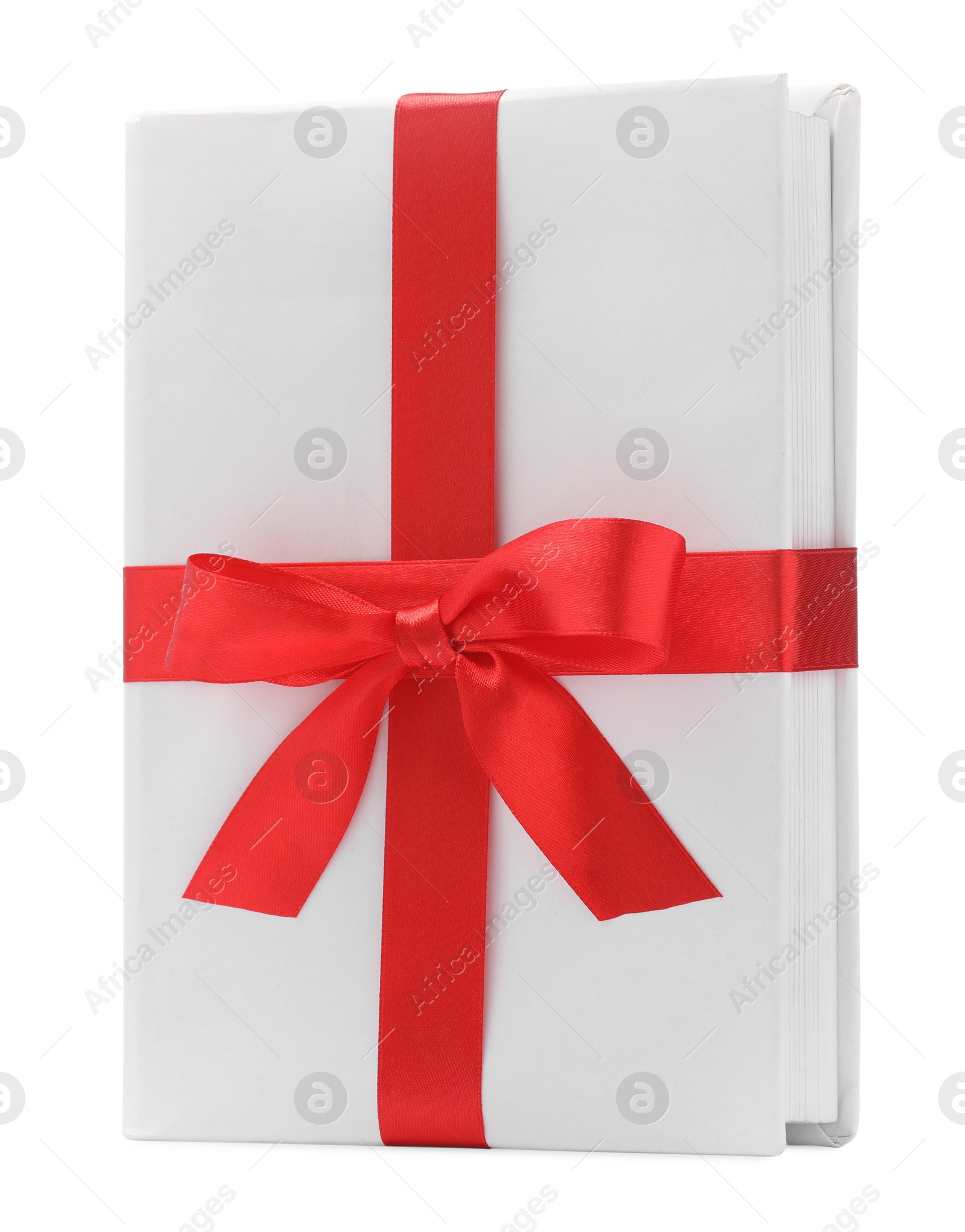 Photo of One book with red ribbon as gift isolated on white