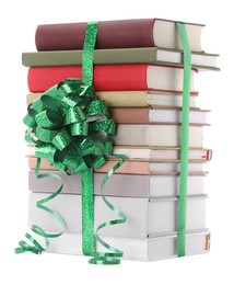 Photo of Stack of books with green bow as gift isolated on white