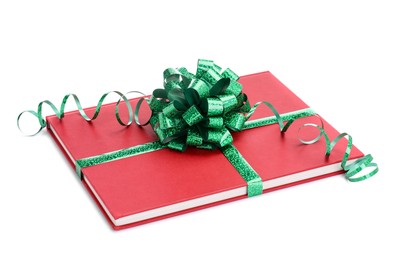 Photo of One book with green bow as gift isolated on white