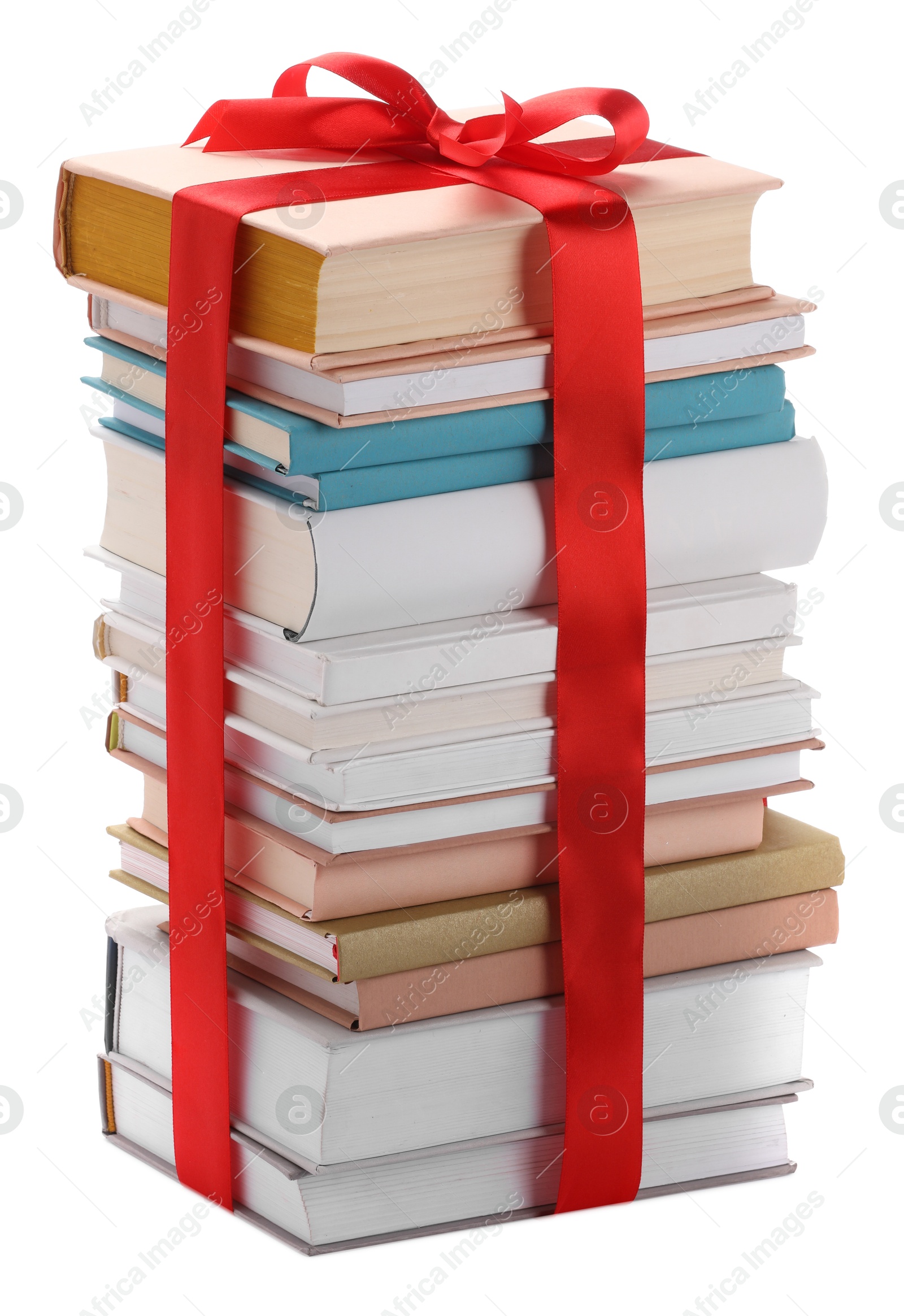 Photo of Stack of books with red ribbon as gift isolated on white