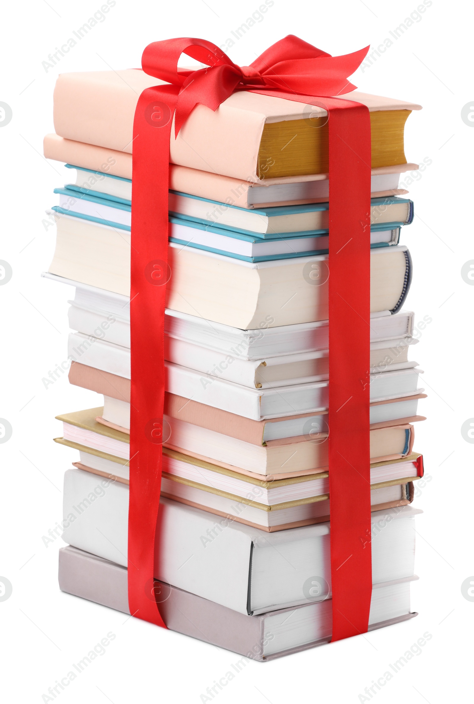 Photo of Stack of books with red ribbon as gift isolated on white