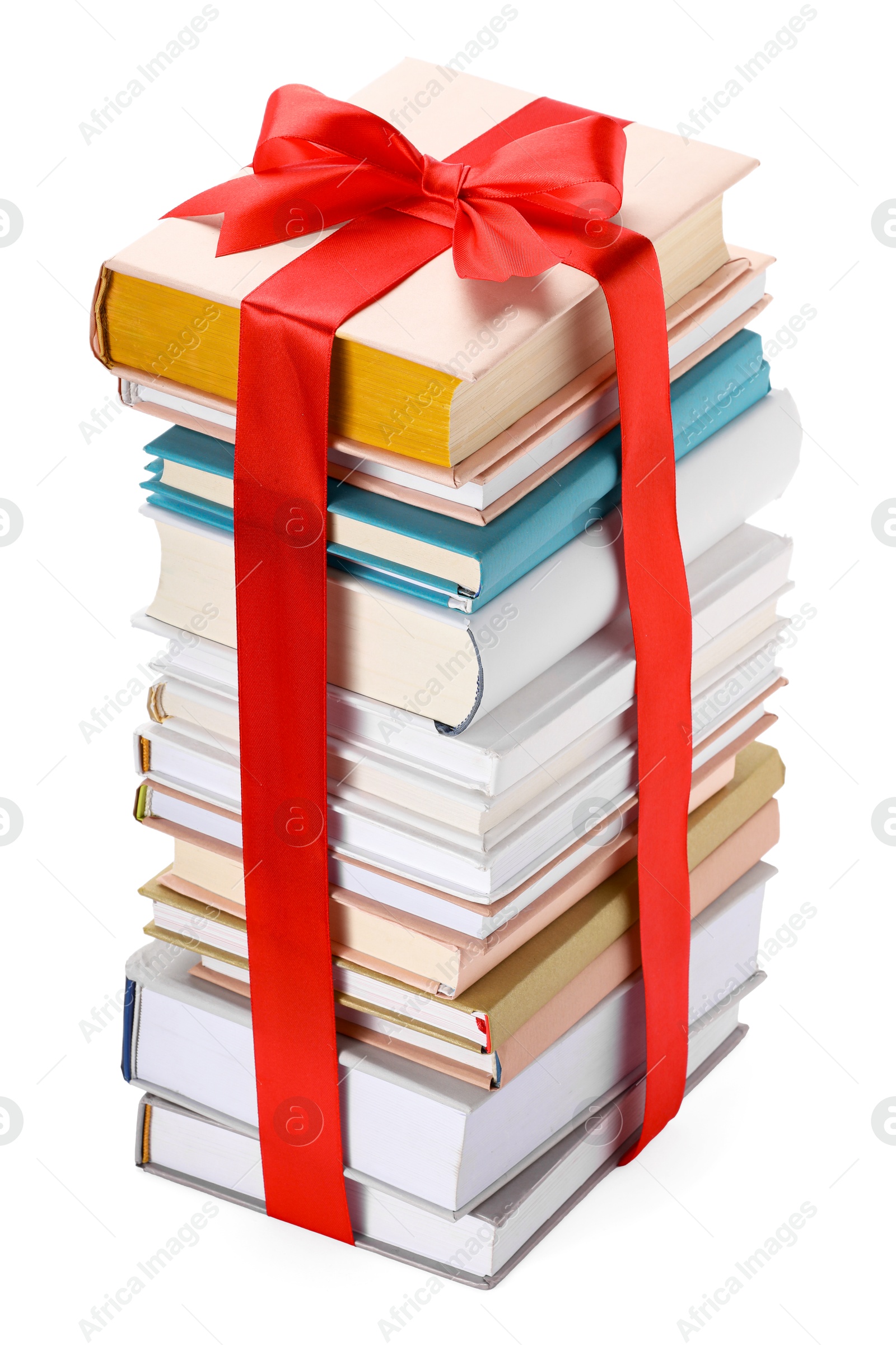 Photo of Stack of books with red ribbon as gift isolated on white