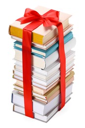 Photo of Stack of books with red ribbon as gift isolated on white