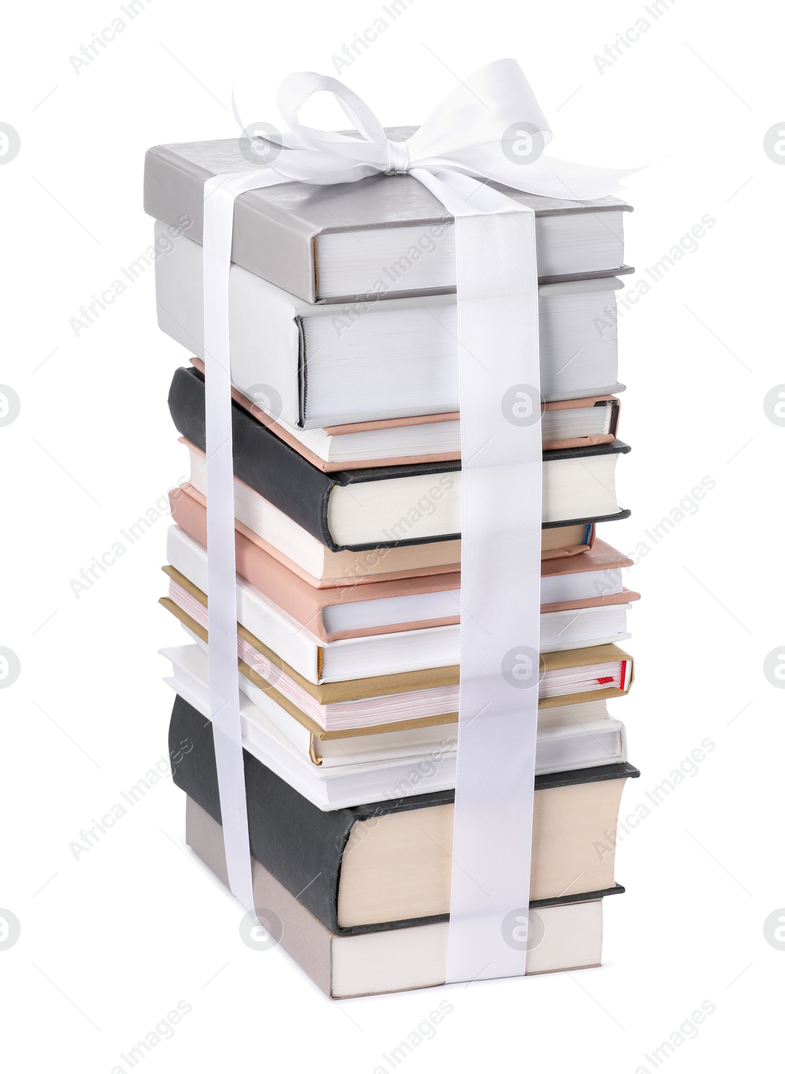 Photo of Stack of books with silk ribbon as gift isolated on white