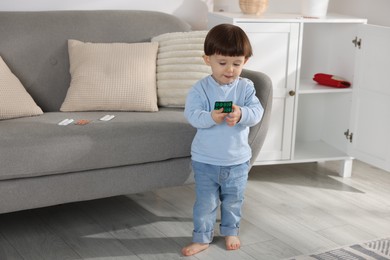 Photo of Little boy with pills at home. Child in danger