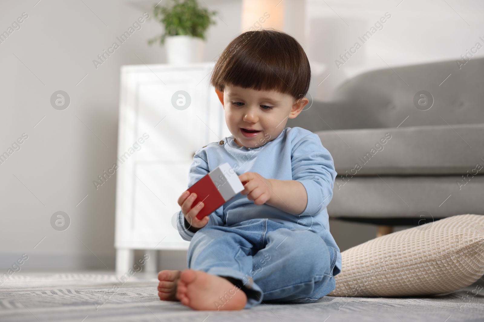 Photo of Little boy playing with matchbox at home. Child in danger