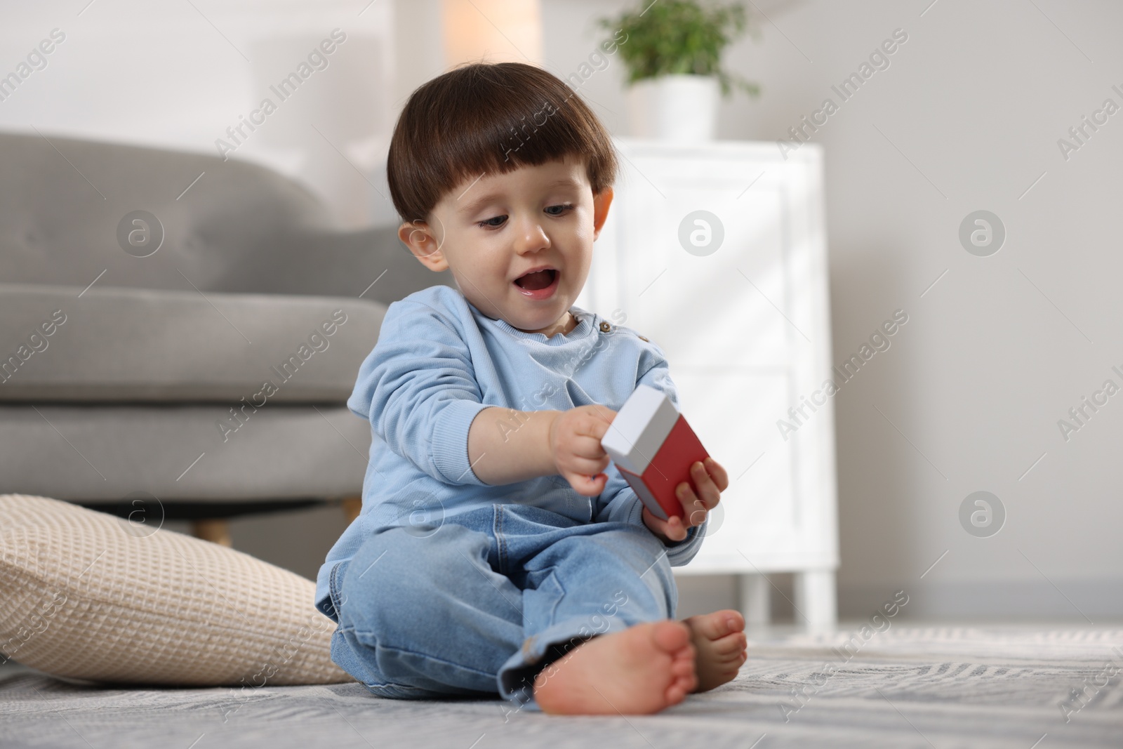 Photo of Little boy playing with matchbox at home. Child in danger