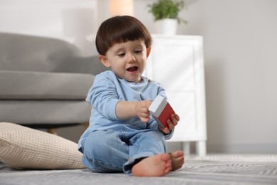 Little boy playing with matchbox at home. Child in danger