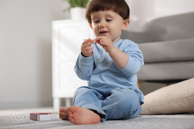 Photo of Little boy playing with matches at home. Child in danger