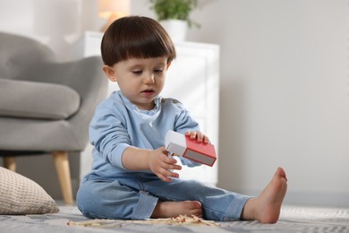 Photo of Little boy playing with matchbox at home. Child in danger