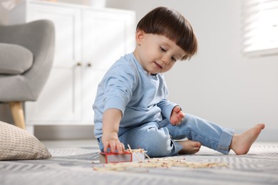 Little boy playing with matches at home. Child in danger