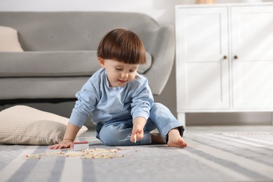 Photo of Little boy playing with matches at home. Child in danger