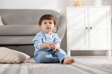 Photo of Little boy playing with matches at home. Child in danger