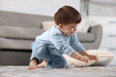 Photo of Little boy playing with matches at home. Child in danger