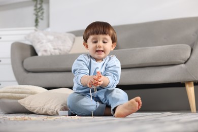 Photo of Little boy playing with matches at home. Child in danger