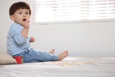 Photo of Little boy playing with matches at home, space for text. Child in danger