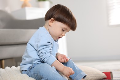 Photo of Little boy playing with matches at home. Child in danger