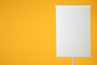 Photo of Flip chart on orange background. Mockup for design