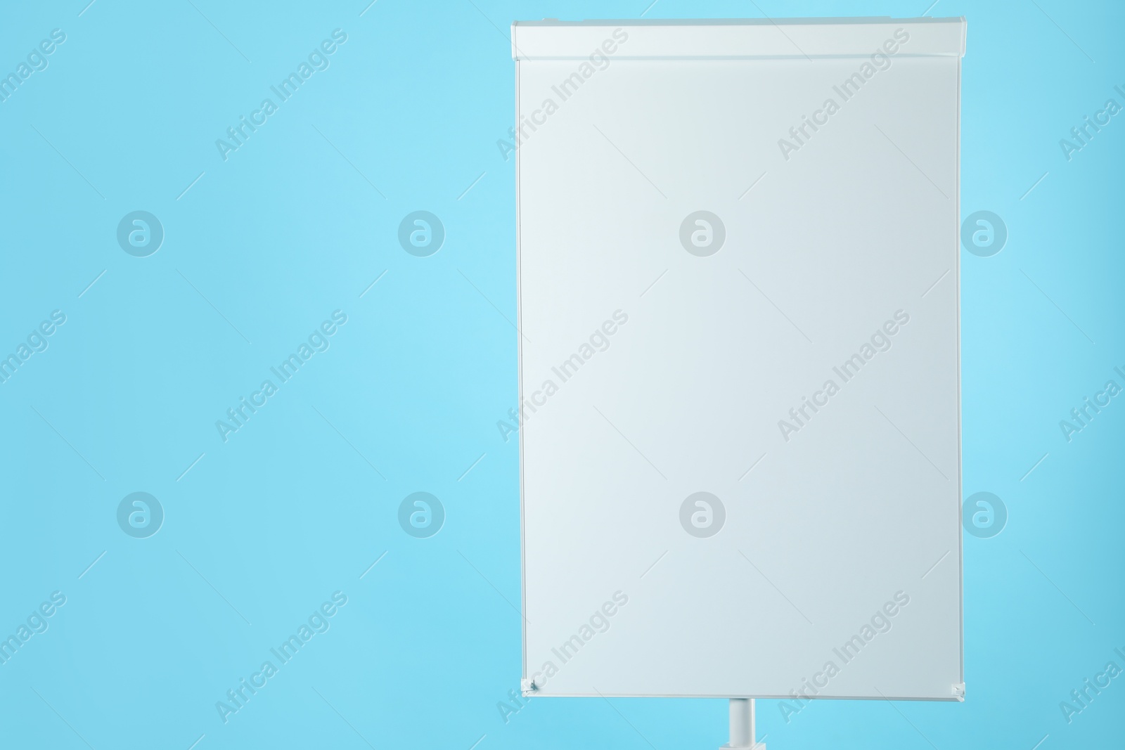 Photo of Flip chart on light blue background. Mockup for design