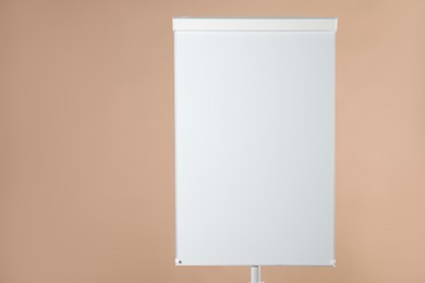 Photo of Flip chart on pale brown background. Mockup for design