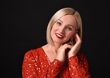 Photo of Smiling woman with perfect makeup on black background